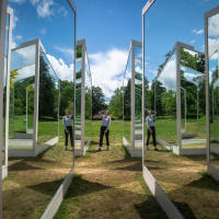 Art installation made of mirrors with person stood in the centre.